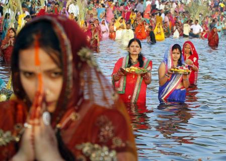 Women worship the Sun god Surya in the waters of the Sun lake during the Hindu religious festival of Chatt Puja in Chandigarh